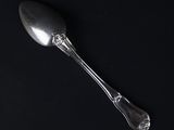 silver spoon on a black background with copy space for text