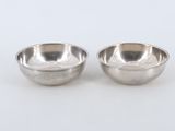a pair of silver plated bowls on a white background