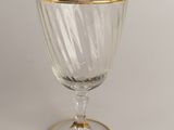 a glass with a gold rim sitting on a table
