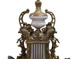 a very ornate gold and white clock on a table