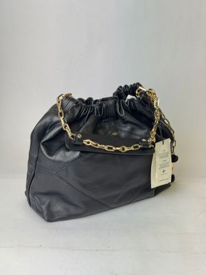 a black purse with a gold chain and a tag on it