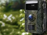 a small camera attached to a tree in the woods