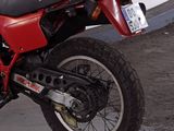a red motorcycle that is parked in a garage