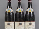 three bottles of wine are lined up on a table