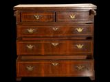 an antique chest of drawers with a marble top on a black background