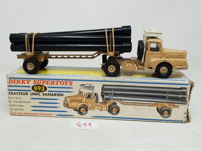 a toy truck with a large pipe on the back of it