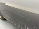 a close up of a car door with scratches on the side of it