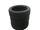 a black planter made out of tires on a white background