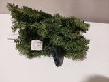 a small christmas tree that is on a white table