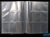 an open book with a silver cover on a black background