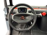 the interior of a car with a steering wheel and dashboard controls