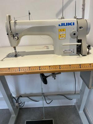 a sewing machine sitting on top of a wooden table