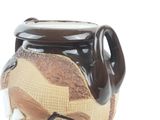 a brown and white vase with a bird on it
