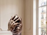 a sculpture on a table in a room with a window