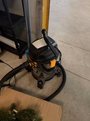 a vacuum that is sitting on the floor next to a box