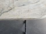 a white marble table with a black metal base