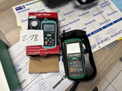 a green and black multimeter sitting on top of a table