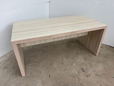 a close up of a wooden table on a concrete floor
