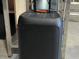 a black suitcase sitting on the floor next to a table