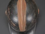 a helmet that has a brown stripe on it