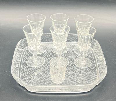 a tray with four glasses on it on a table