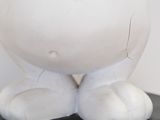 a close up of a statue of a person with his hands on his head