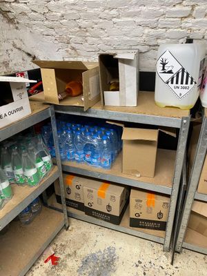 many boxes and cans of water on the shelves