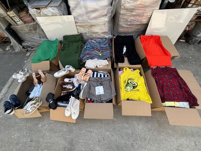 many boxes of clothing that are sitting on the ground