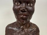 sculpture of a woman ' s head on a table with a white background