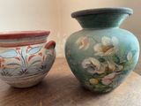two vases that are sitting on a wooden table