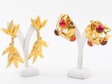 three pairs of gold - plated earrings with leaves and berries