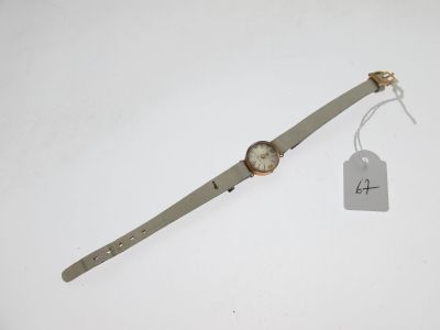 a close up of a wrist watch on a white surface with a price tag