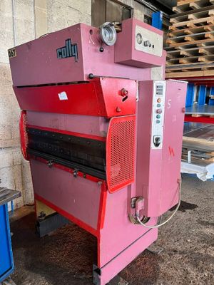 a pink machine that is sitting in a warehouse
