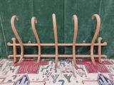 a wooden rack that has a bunch of hooks on it