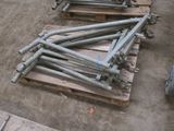 many pieces of metal sitting on pallets on the ground
