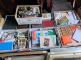 many boxes of books sitting on a table in a room