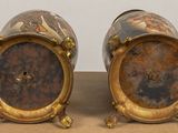 two vases that are sitting on a table
