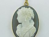 a close up of a white and black cameo pendant on a white background