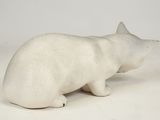 a white polar bear statue on a white surface