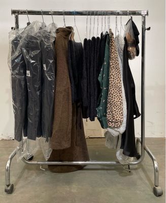 a rack of clothes that is on display in a room