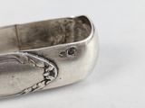a close up of a silver ring on a white surface