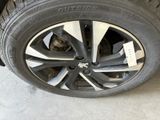 the tire of a car with a sticker on it ' s rim