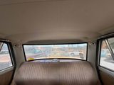 a bed in the back of a car with a view of a parking lot