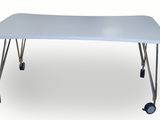 the table is white and has wheels on the legs