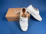 pair of white leather shoes with tassels in front of a box