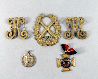 three medals and a medal laying on a table next to a coin