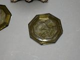 three pieces of silver and glass on a table