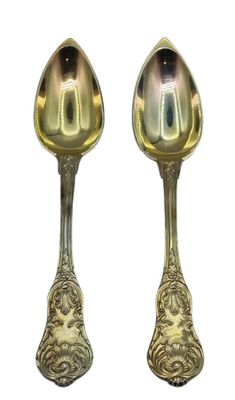 pair of silver spoons on a white background with a white background