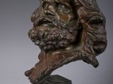 pair of bronze busts of a bearded man and a bust of a woman