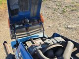 a blue truck with a large engine in the back of it